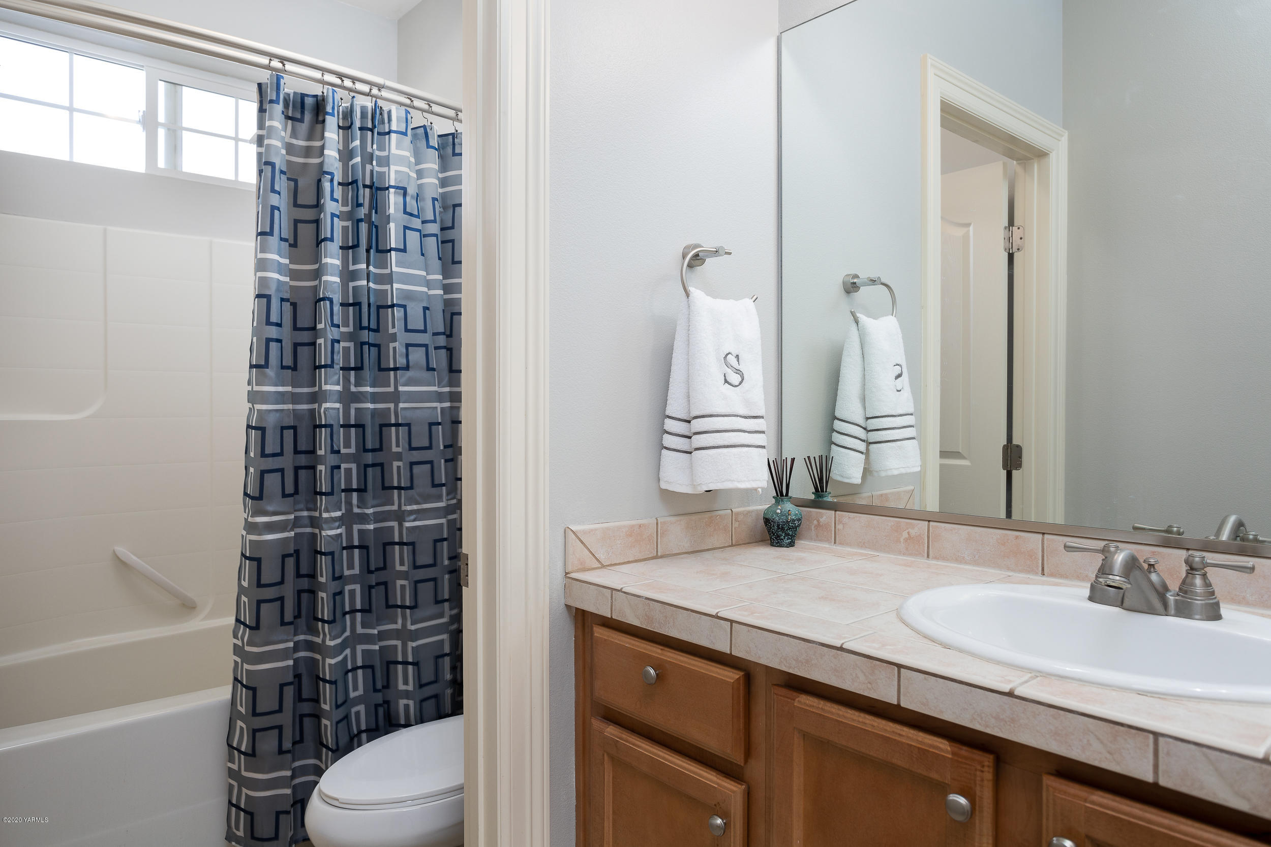 10903 Zier Road Yakima, WA 98908 - Photo 22 of 31 a bathroom with a granite countertop sink a toilet and shower