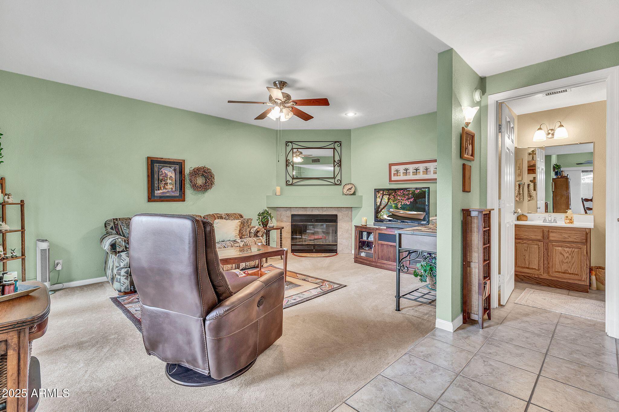 5640 East Bell Road, Unit 1055 Scottsdale, AZ 85254 - Photo 10 of 39 a living room with furniture and a fireplace
