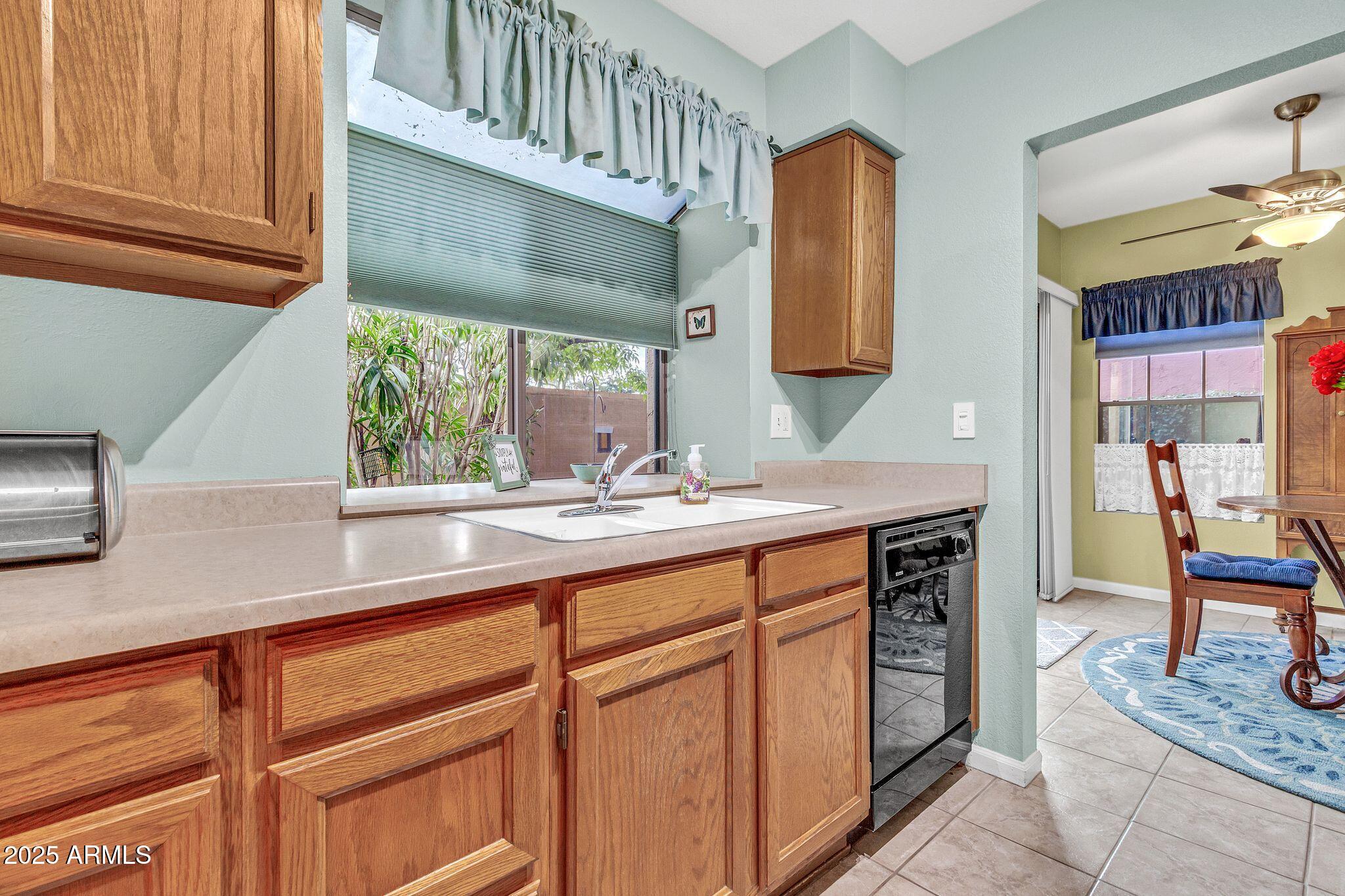 5640 East Bell Road, Unit 1055 Scottsdale, AZ 85254 - Photo 16 of 39 a kitchen with stainless steel appliances granite countertop a sink and a cabinets