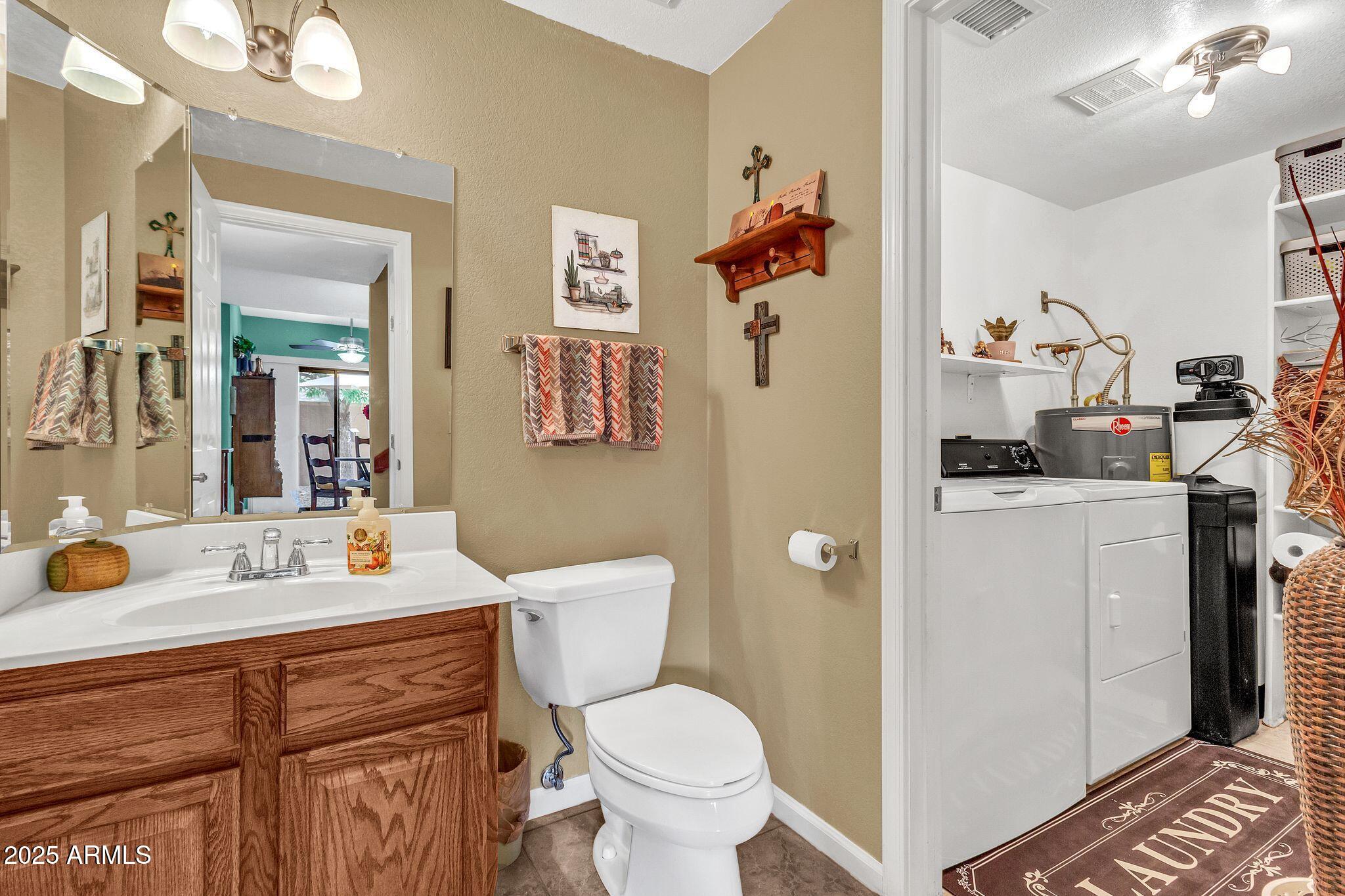 5640 East Bell Road, Unit 1055 Scottsdale, AZ 85254 - Photo 17 of 39 a bathroom with a sink a toilet and a mirror