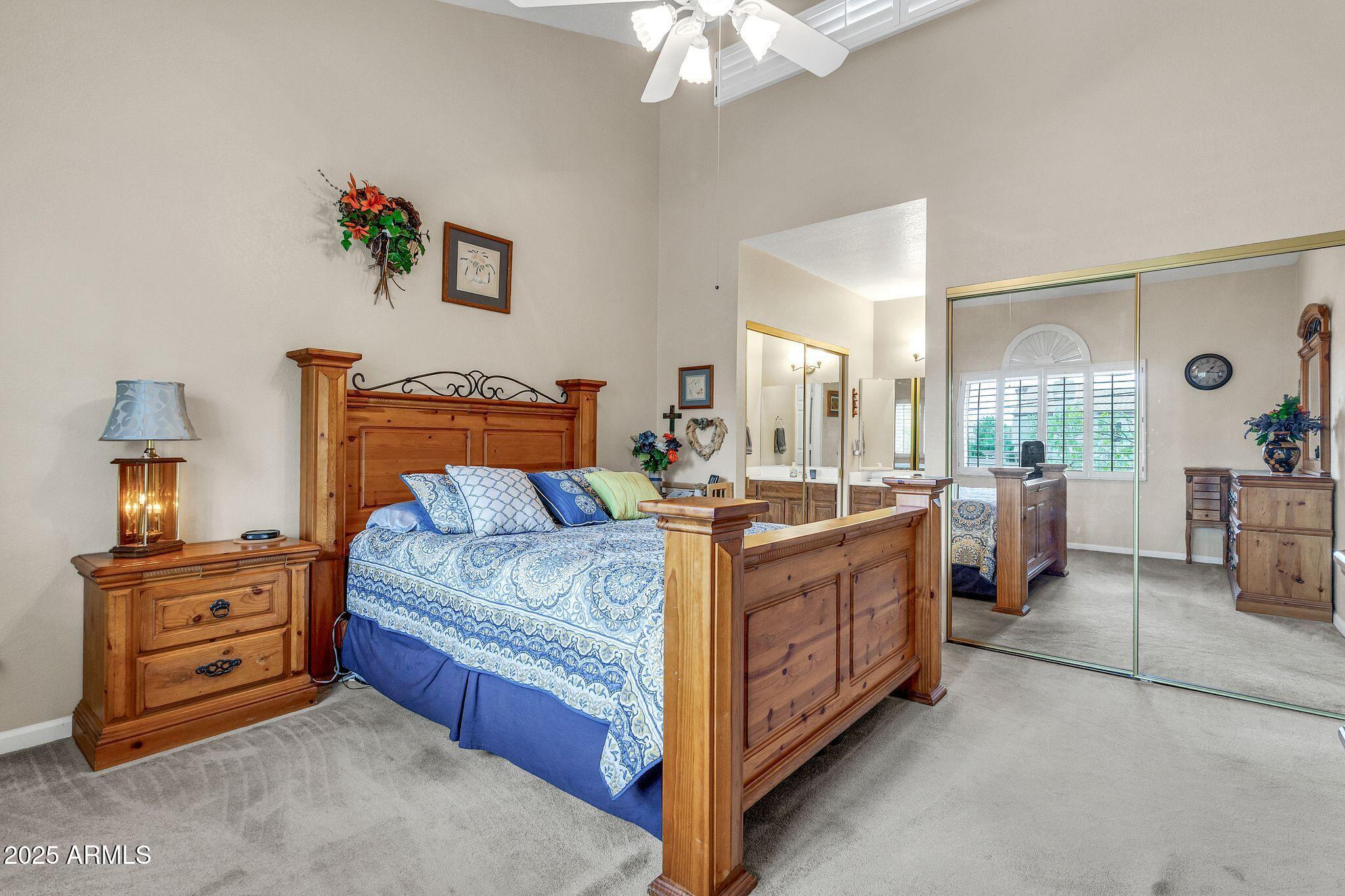 5640 East Bell Road, Unit 1055 Scottsdale, AZ 85254 - Photo 20 of 39 a bed room with a bed and a chandelier