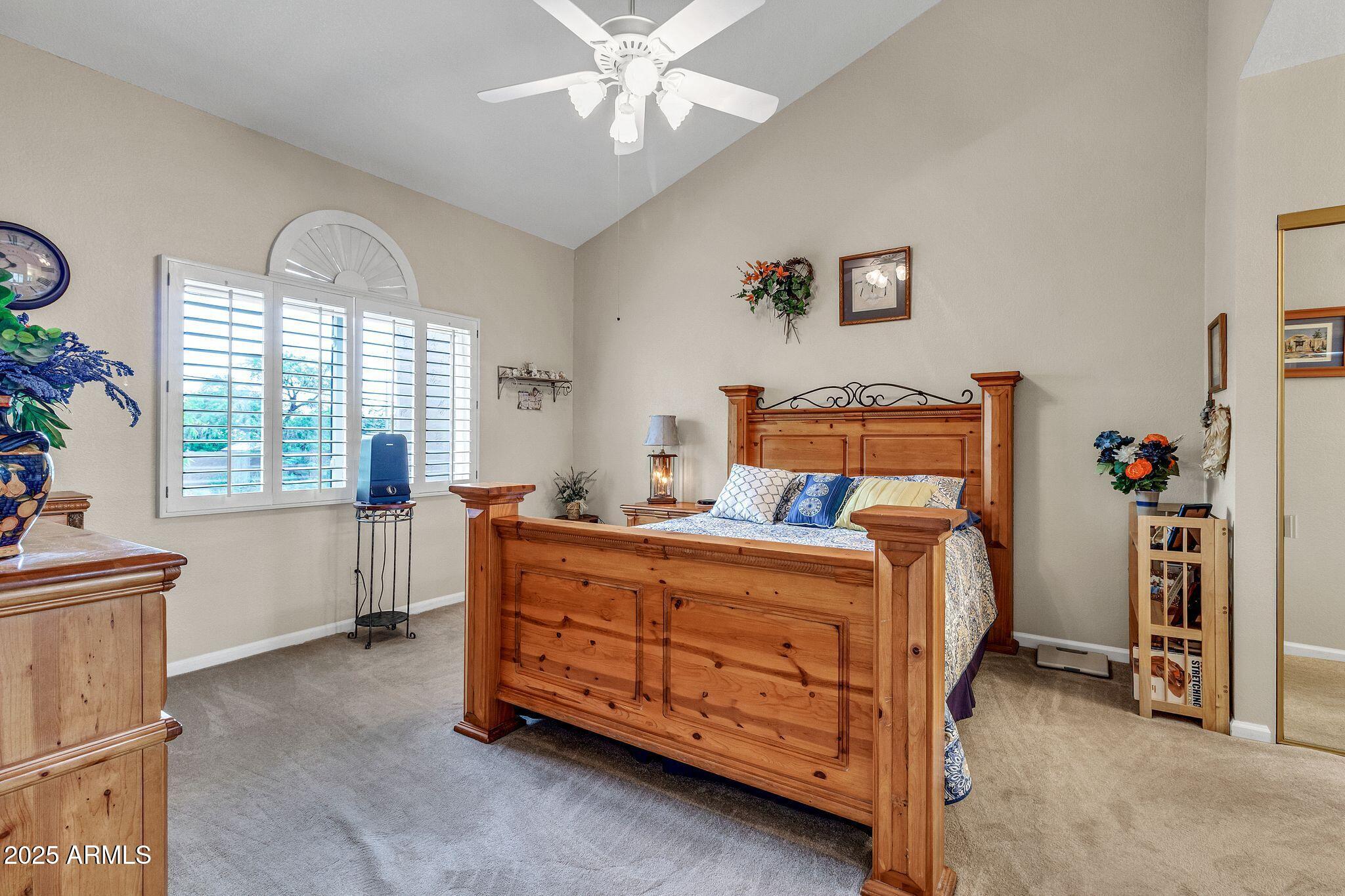 5640 East Bell Road, Unit 1055 Scottsdale, AZ 85254 - Photo 21 of 39 a bed room with a bed and a chandelier