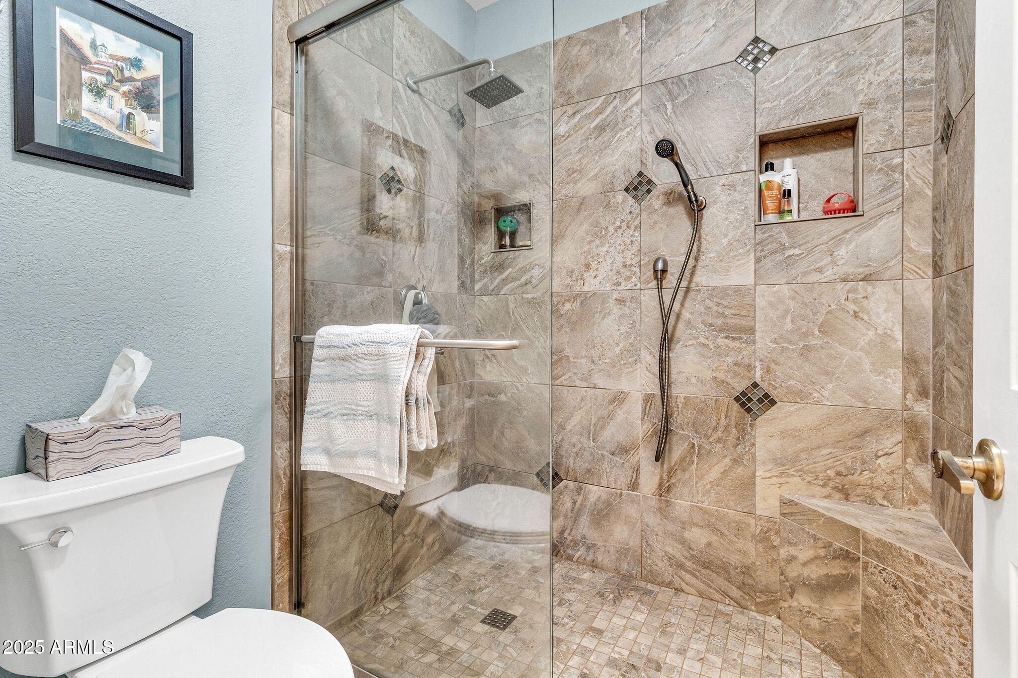 5640 East Bell Road, Unit 1055 Scottsdale, AZ 85254 - Photo 23 of 39 a bathroom with a toilet sink and shower
