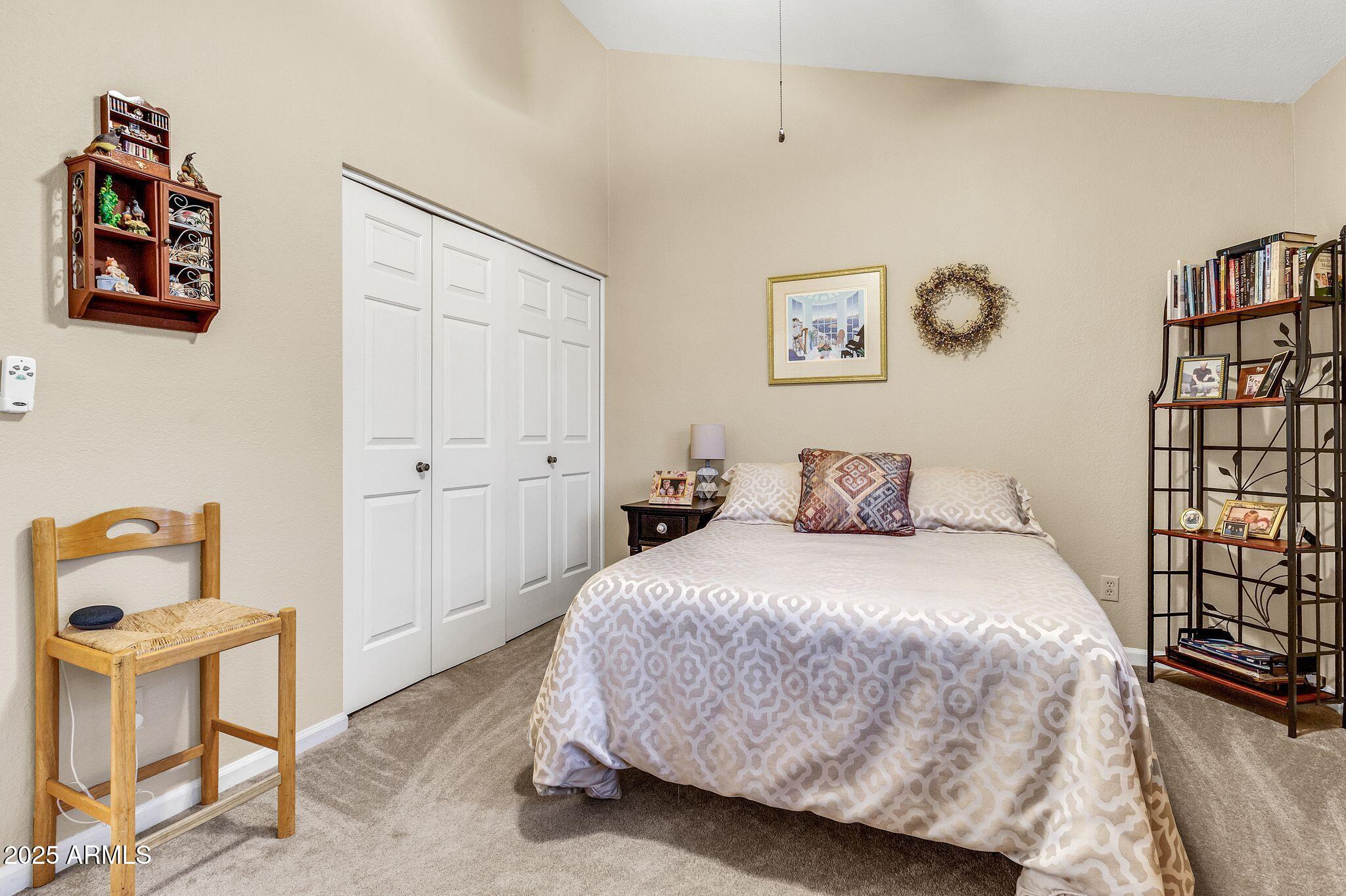 5640 East Bell Road, Unit 1055 Scottsdale, AZ 85254 - Photo 26 of 39 a bedroom with a bed and a window