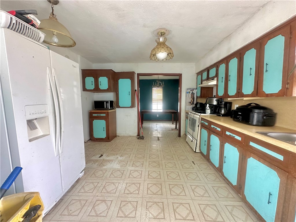 801 Ruben Chavez Road Robstown, TX 78380 - Photo 5 of 18 a view of a kitchen with fridge and a sink