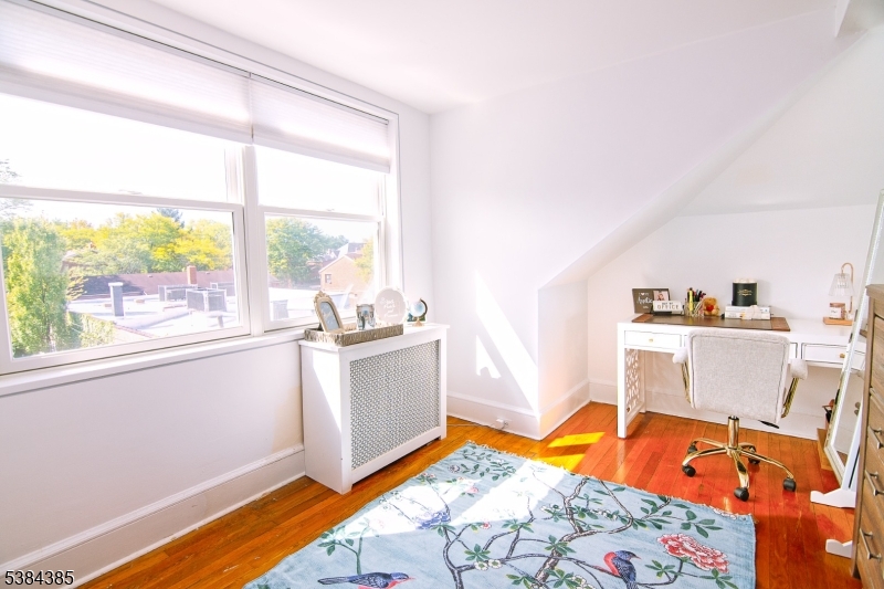 306 Springfield Avenue, Unit 3 Summit, NJ 07901 - Photo 15 of 20 a bed room with a bed and a window
