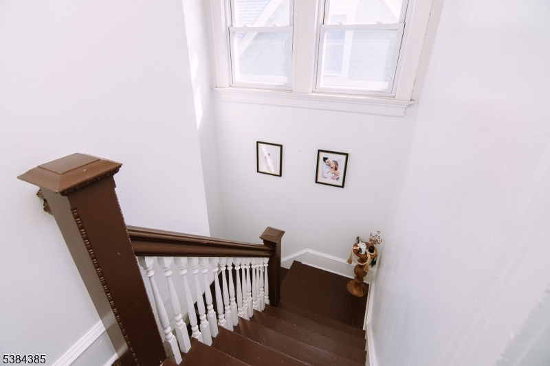 306 Springfield Avenue, Unit 3 Summit, NJ 07901 - Photo 16 of 20 a view of a hallway with wooden floor and a window