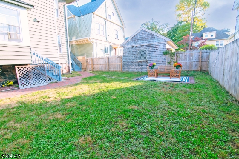 306 Springfield Avenue, Unit 3 Summit, NJ 07901 - Photo 20 of 20 a backyard of a house with table and chairs