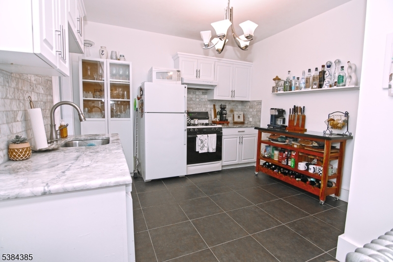 306 Springfield Avenue, Unit 3 Summit, NJ 07901 - Photo 9 of 20 a kitchen with stainless steel appliances granite countertop a stove a sink dishwasher and a refrigerator with wooden floor
