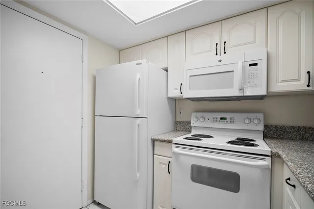 a white refrigerator freezer and a stove top oven
