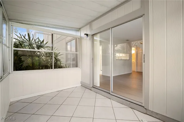 a spacious bathroom with a glass shower door and a glass door