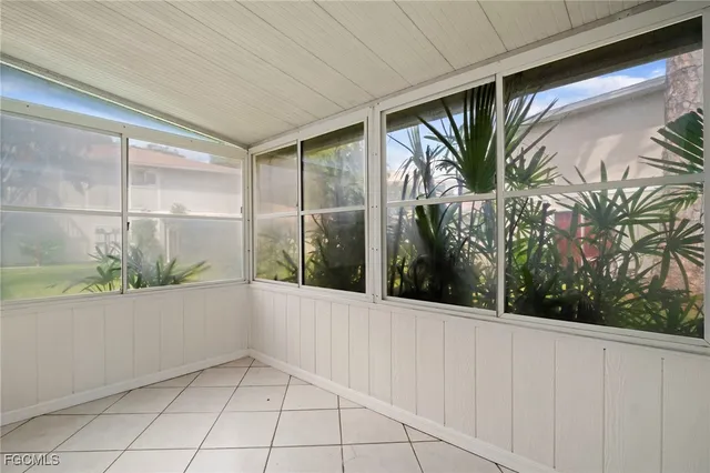 a view of a hallway with wooden floor and windows