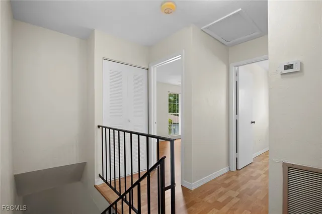 a view of a hallway with wooden floor and entryway