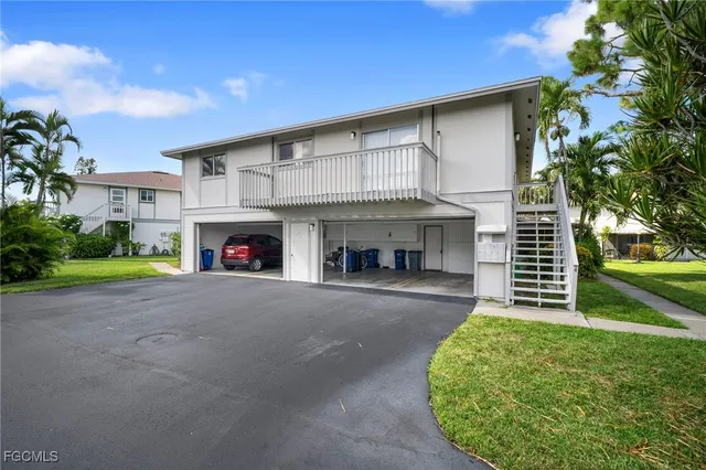 a view of a house with a yard and garage
