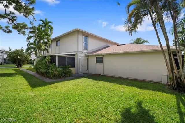 a front view of a house with a yard patio and fire pit