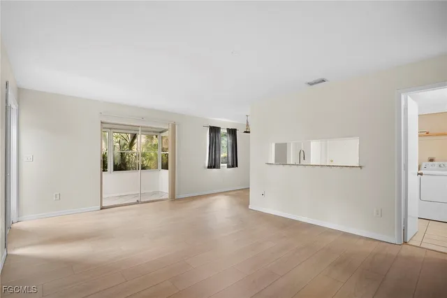an empty room with windows and closet