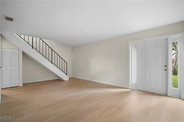 a view of an empty room with stairs