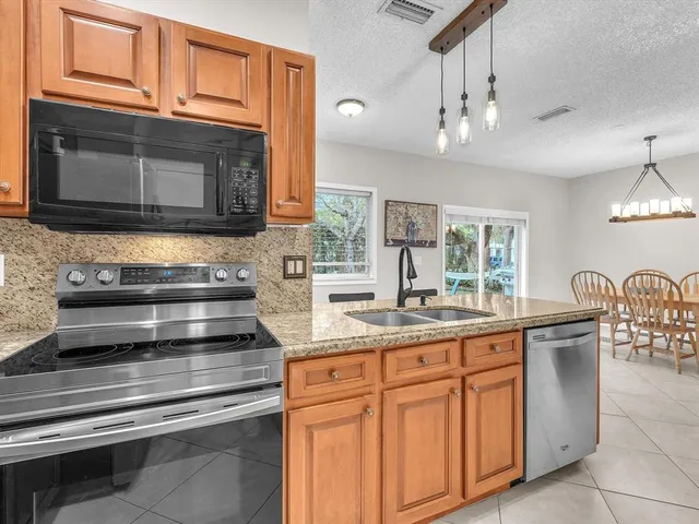 a kitchen with stainless steel appliances granite countertop a stove and cabinets