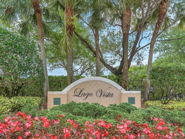 a view of a sign in front of flowers