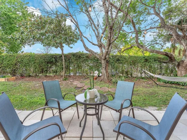 a patio with a yard table and chairs