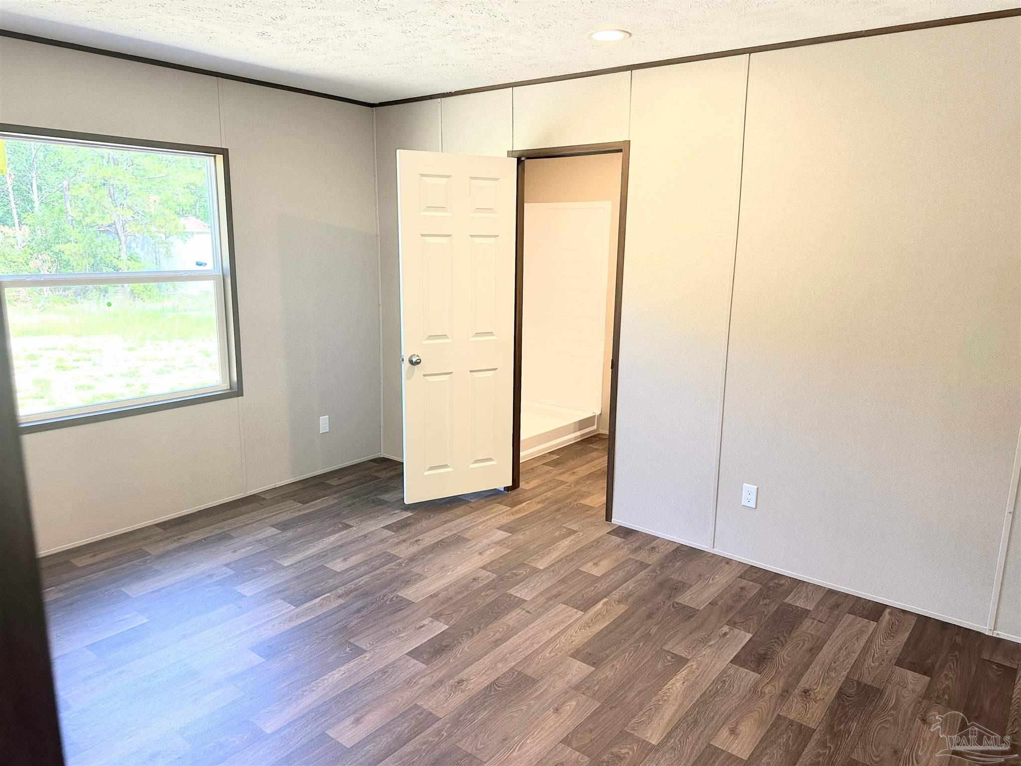 0 T Bridge Road Red Level, AL 36474 - Photo 11 of 25 an empty room with wooden floor and windows