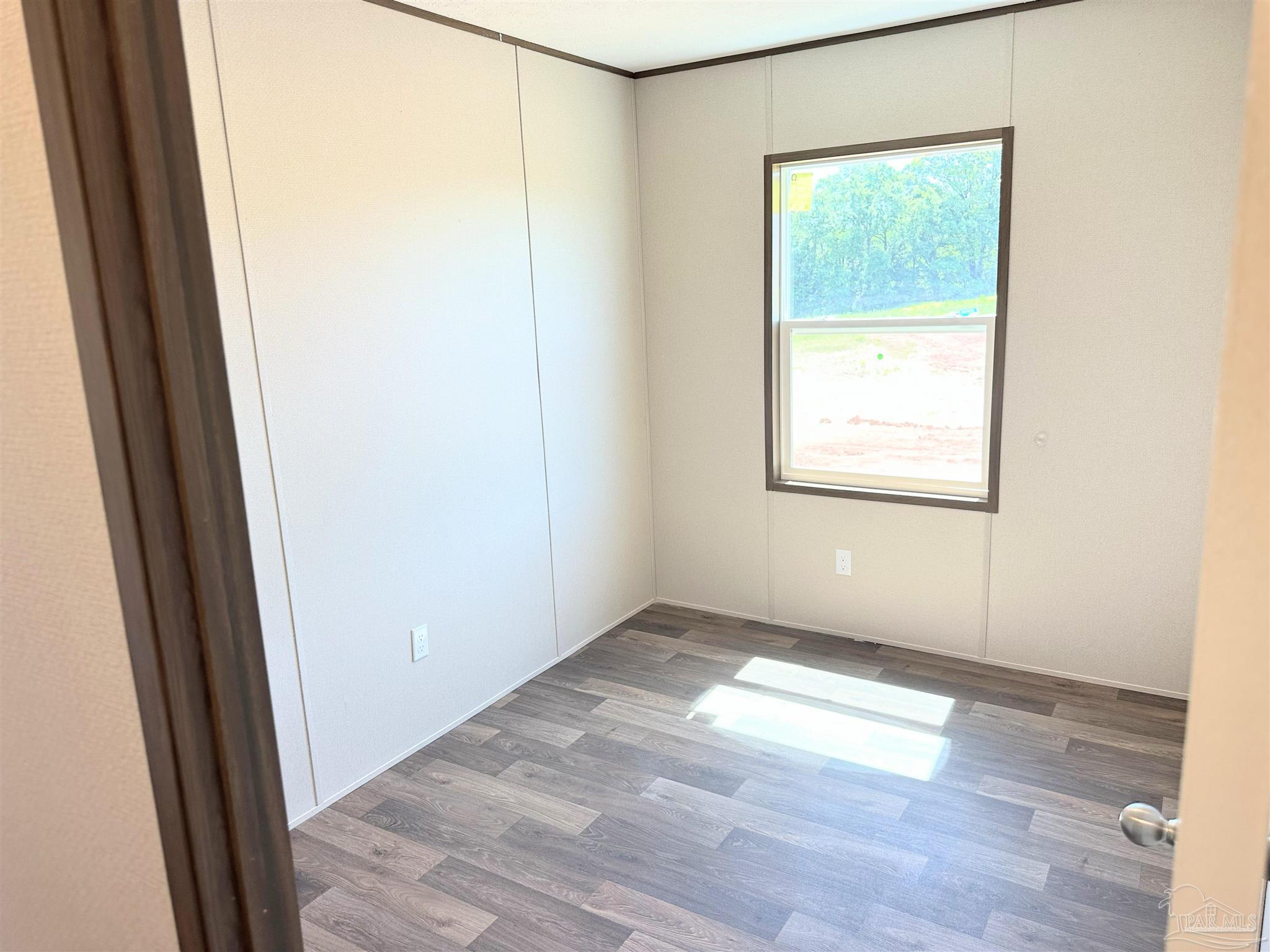 0 T Bridge Road Red Level, AL 36474 - Photo 8 of 25 an empty room with wooden floor and windows