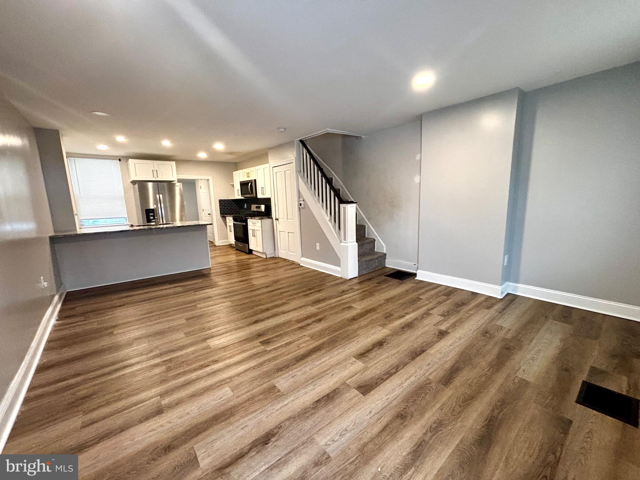 a view of a living room a kitchen with a sink