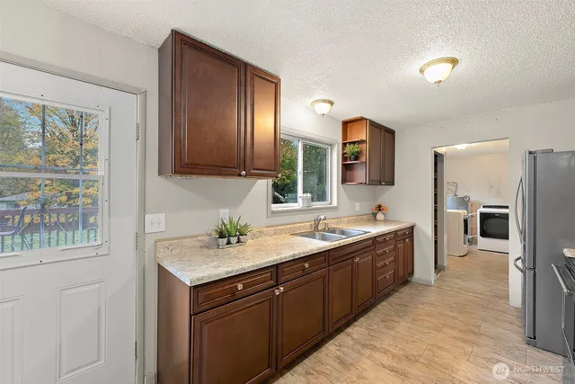 a bathroom with a sink double vanity granite tub shower and a mirror