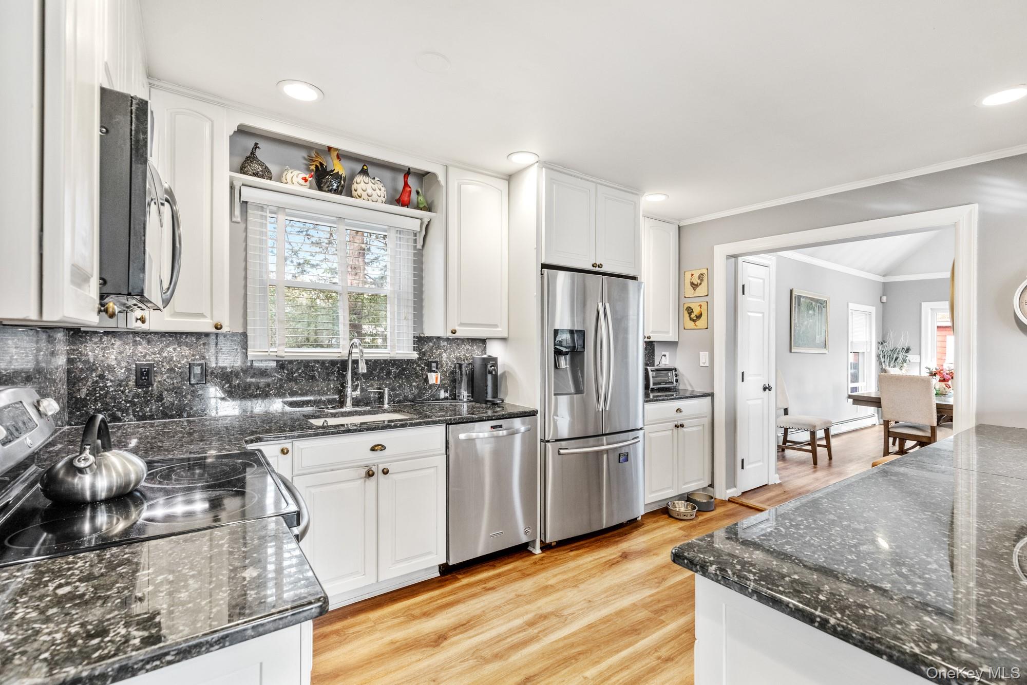 79 East Tiana Road Hampton Bays, NY 11946 - Photo 13 of 26 a kitchen with a sink stove and refrigerator