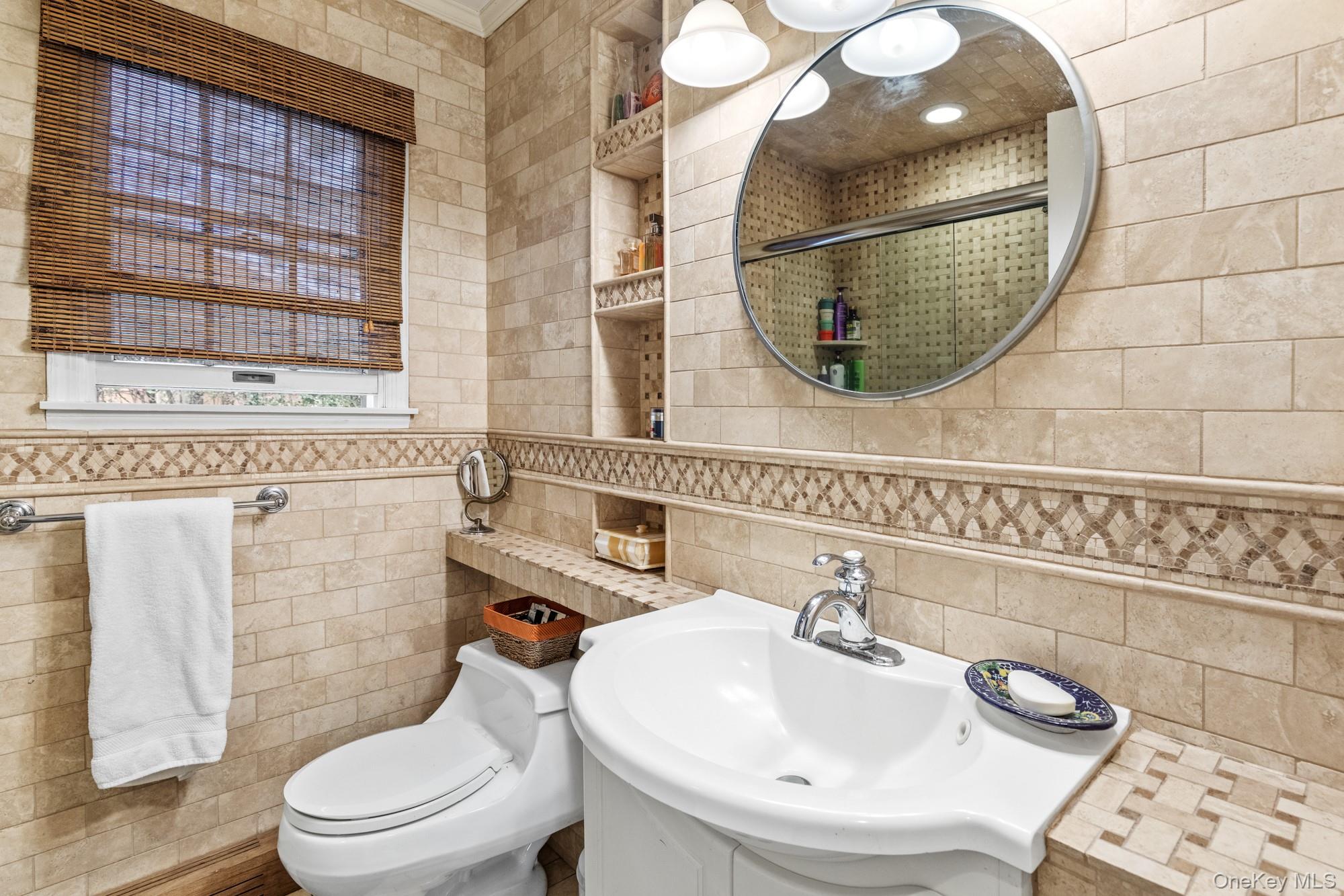 79 East Tiana Road Hampton Bays, NY 11946 - Photo 16 of 26 a bathroom with a sink and a mirror