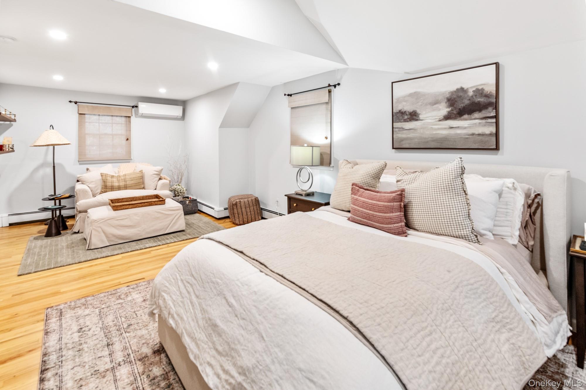 79 East Tiana Road Hampton Bays, NY 11946 - Photo 19 of 26 a spacious bedroom with a bed and glass windows