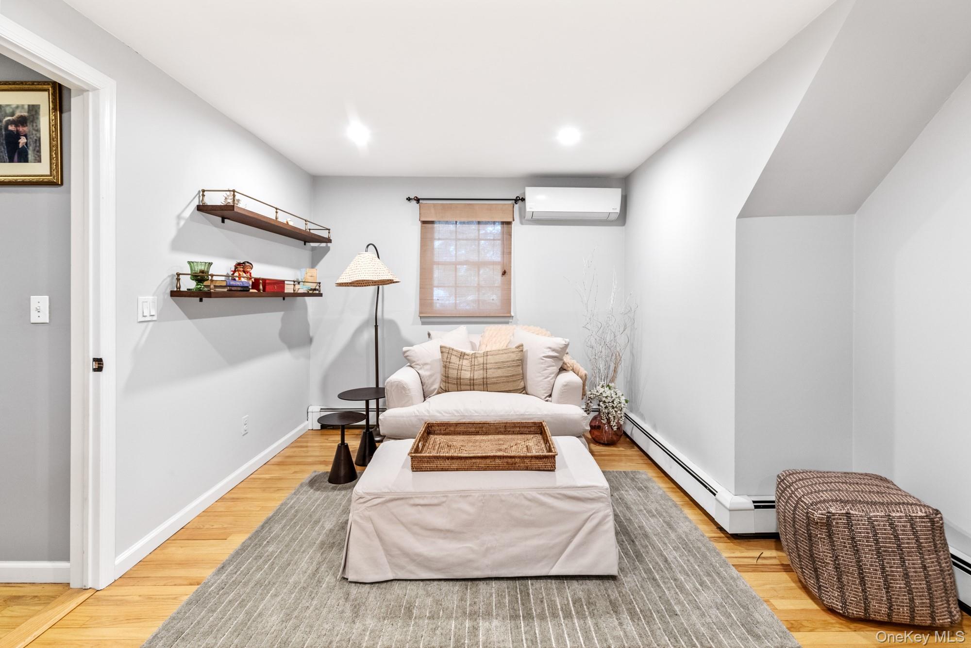 79 East Tiana Road Hampton Bays, NY 11946 - Photo 20 of 26 a bed room with a bed and a couch