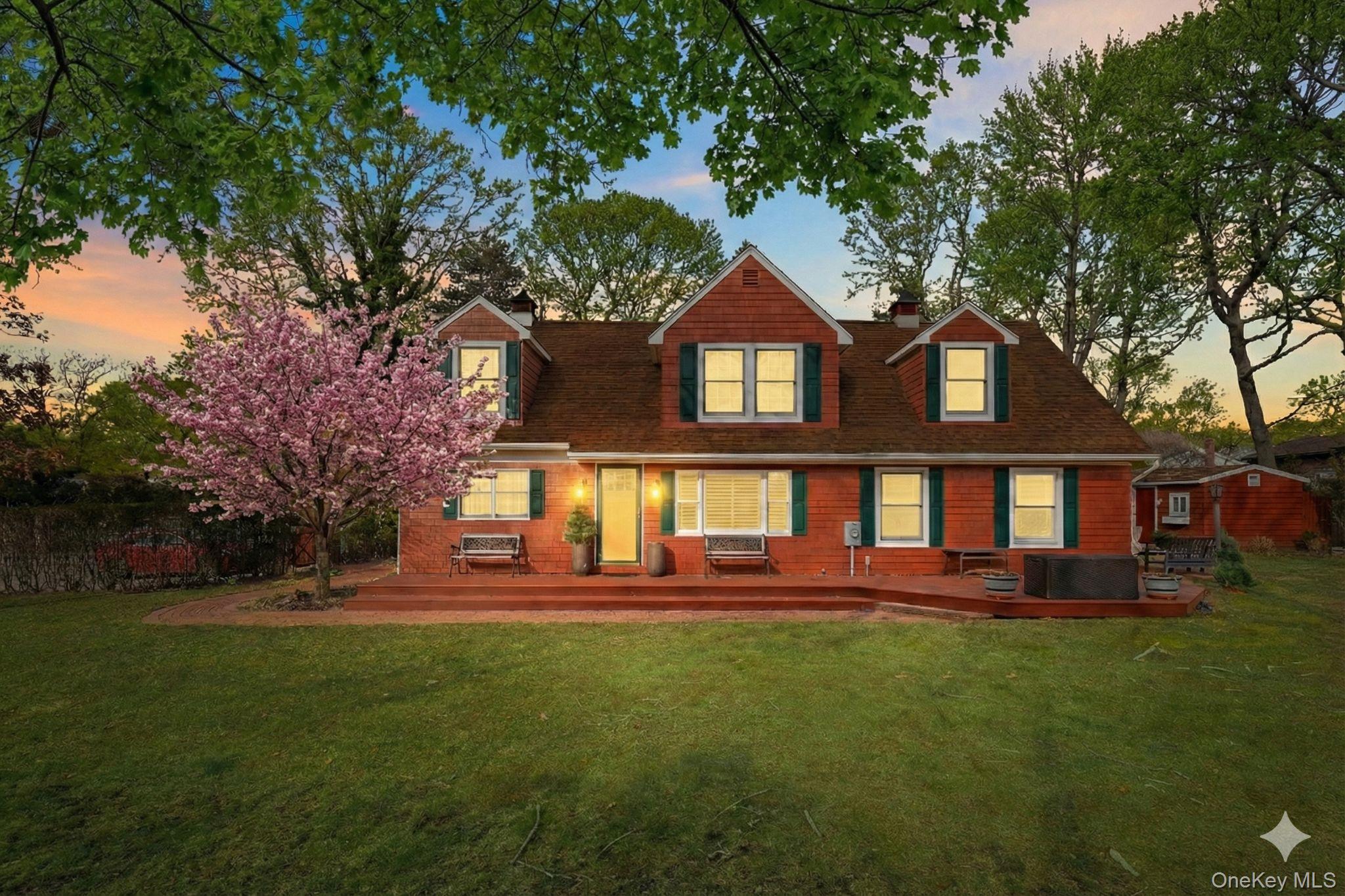 79 East Tiana Road Hampton Bays, NY 11946 - Photo 2 of 26 a front view of a house with a yard