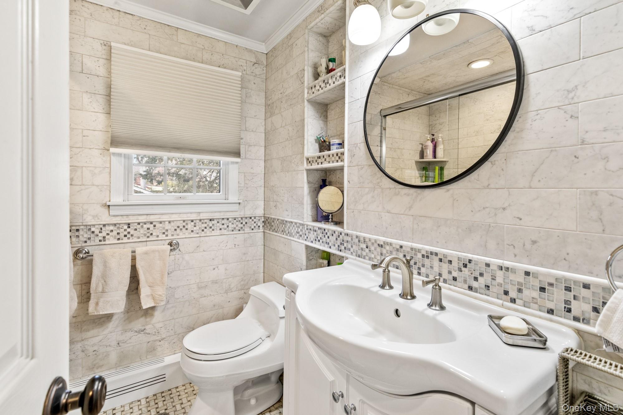 79 East Tiana Road Hampton Bays, NY 11946 - Photo 21 of 26 a bathroom with a sink and a mirror