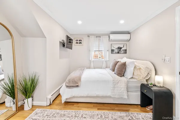 a bedroom with a bed and a potted plant