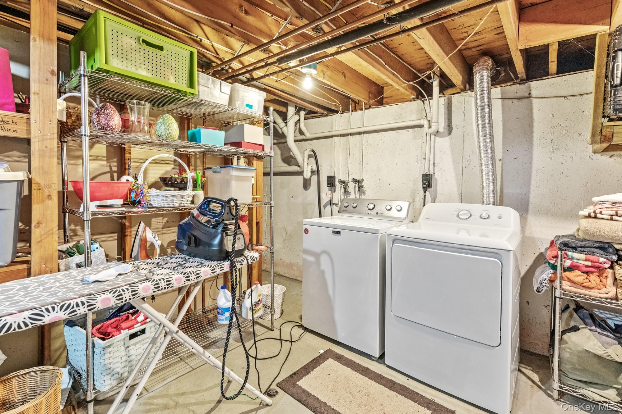 79 East Tiana Road Hampton Bays, NY 11946 - Photo 24 of 26 a utility room with dryer and washer