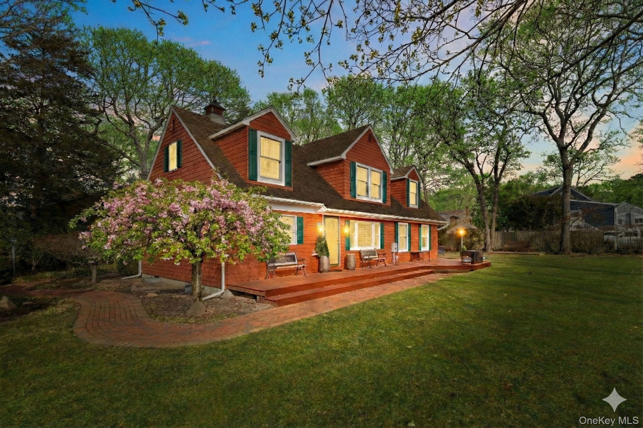 79 East Tiana Road Hampton Bays, NY 11946 - Photo 4 of 26 a front view of a house with a yard