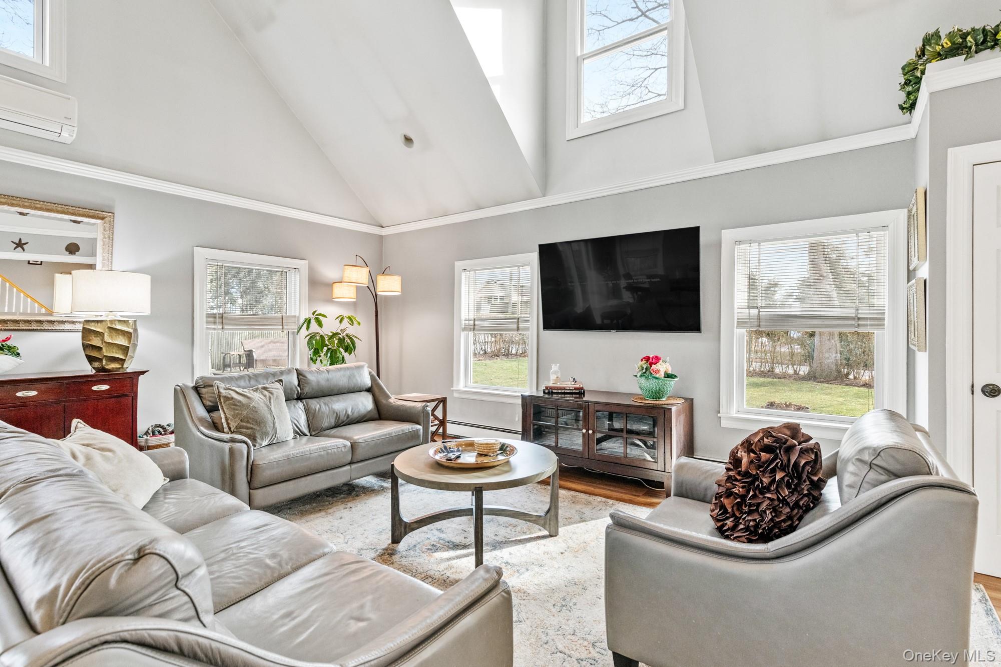 79 East Tiana Road Hampton Bays, NY 11946 - Photo 9 of 26 a living room with furniture and a flat screen tv