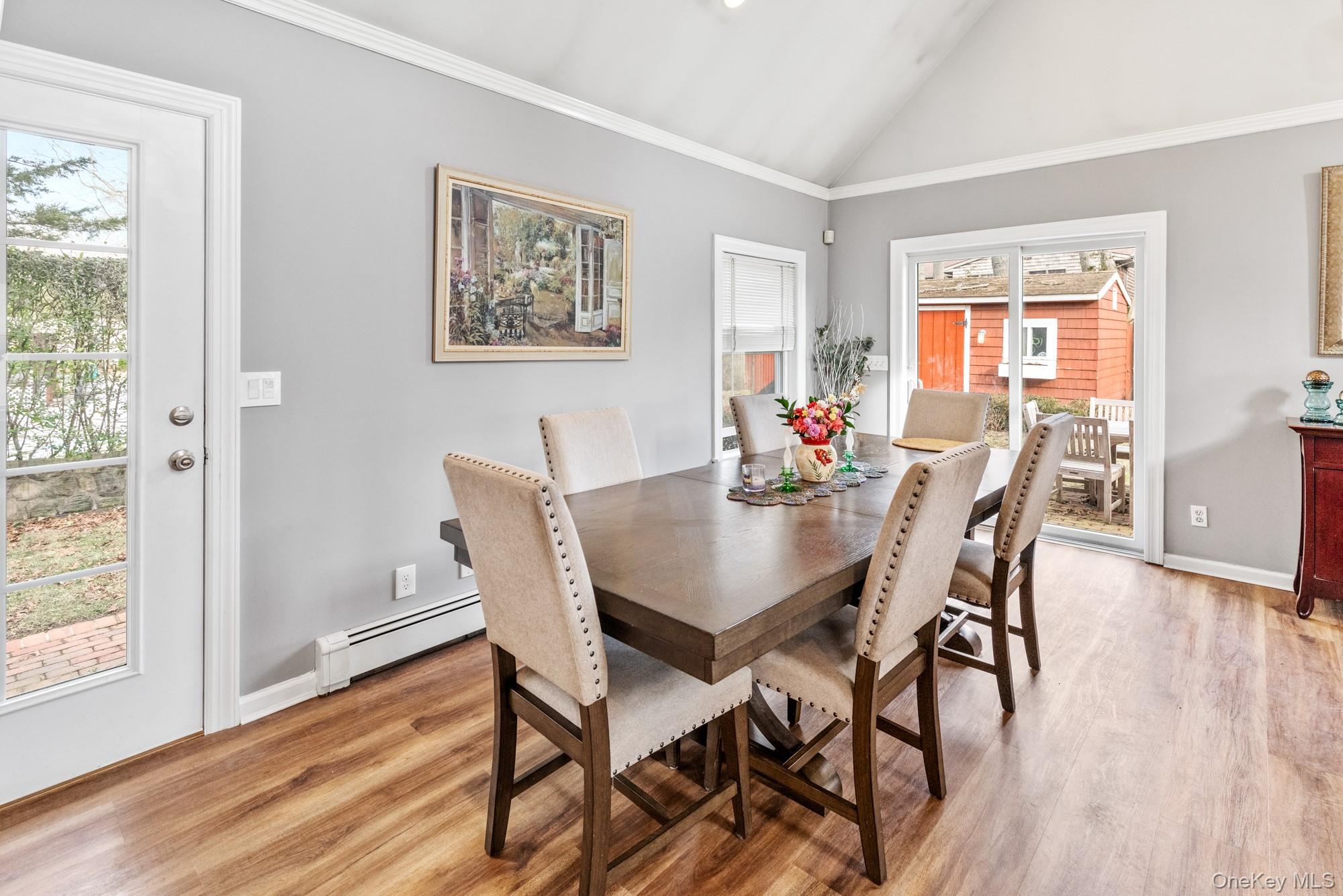 79 East Tiana Road Hampton Bays, NY 11946 - Photo 10 of 26 a view of a dining room with furniture window and wooden floor