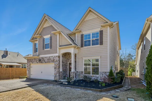 a front view of a house with a yard