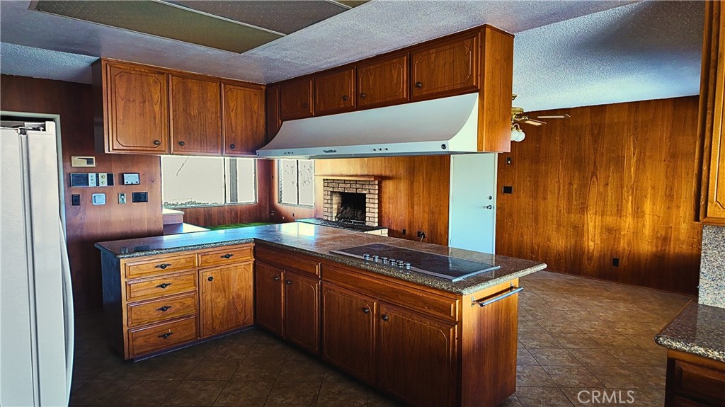 17250 Waugh Ranch Road Riverside, CA 92503 - Photo 12 of 16 a kitchen with stainless steel appliances granite countertop a stove refrigerator and cabinets