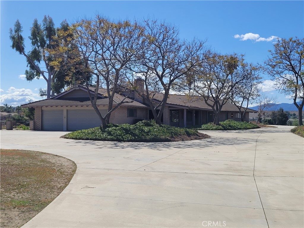17250 Waugh Ranch Road Riverside, CA 92503 - Photo 6 of 16 a front view of a house with a yard and garage