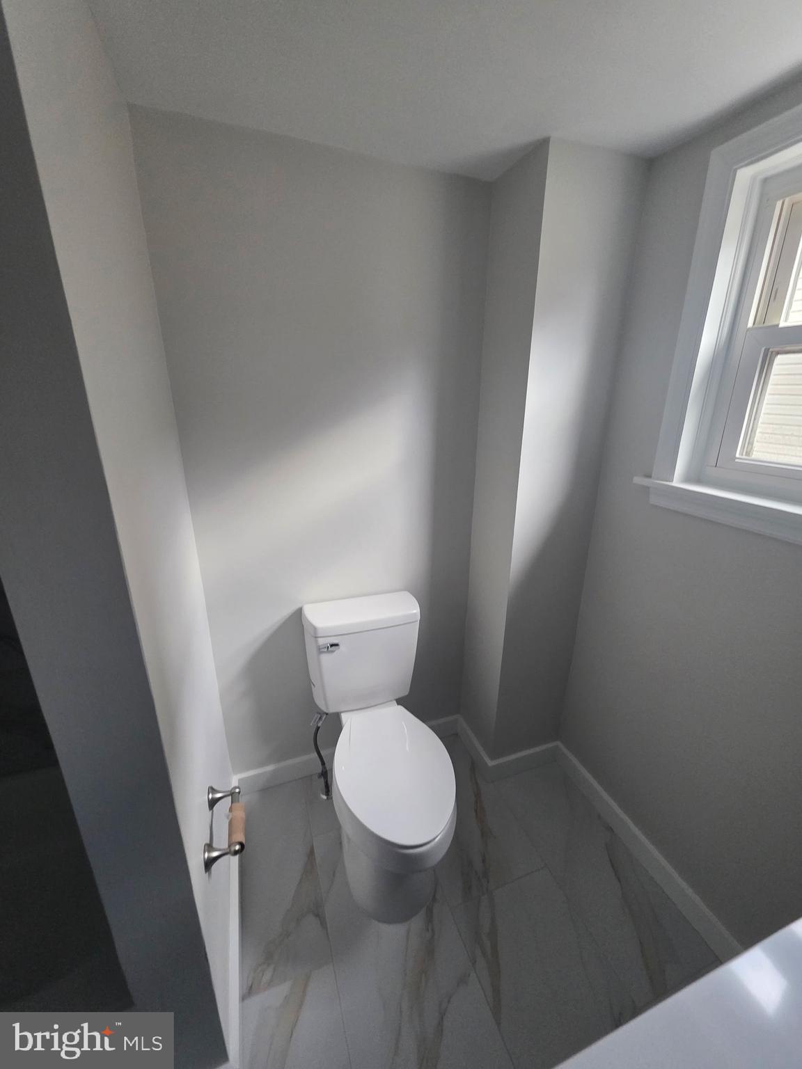 105 Mecray Lane Maple Shade, NJ 08052 - Photo 12 of 12 a white toilet sitting in a bathroom next to a window