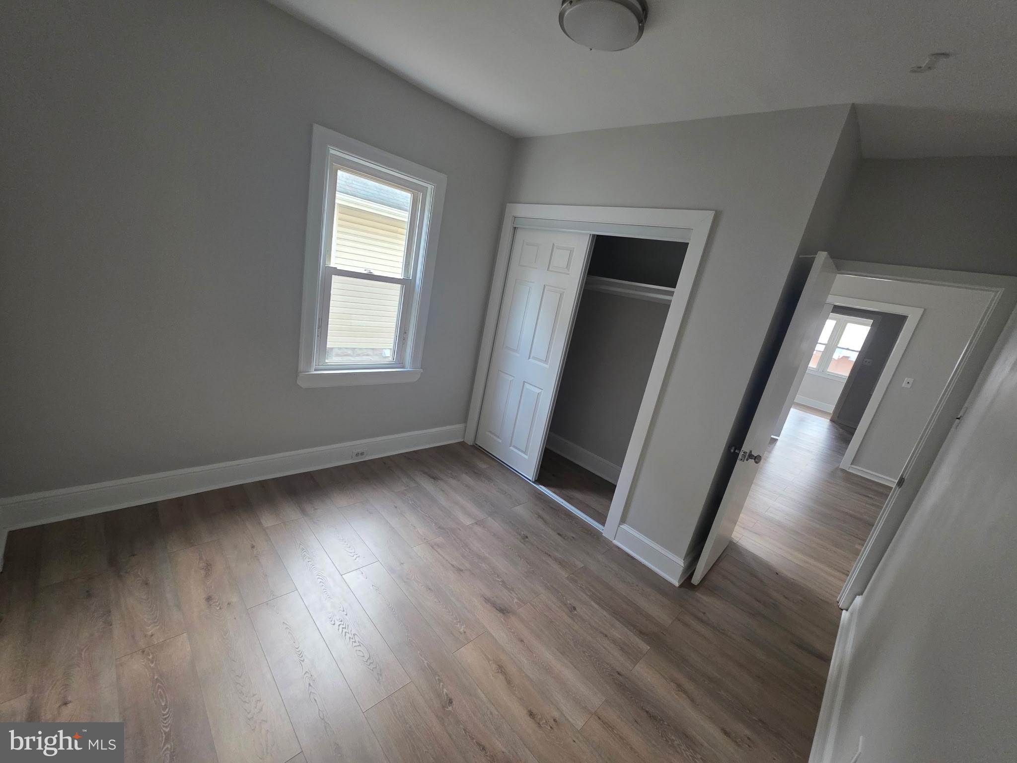105 Mecray Lane Maple Shade, NJ 08052 - Photo 5 of 12 an empty room with wooden floor and windows