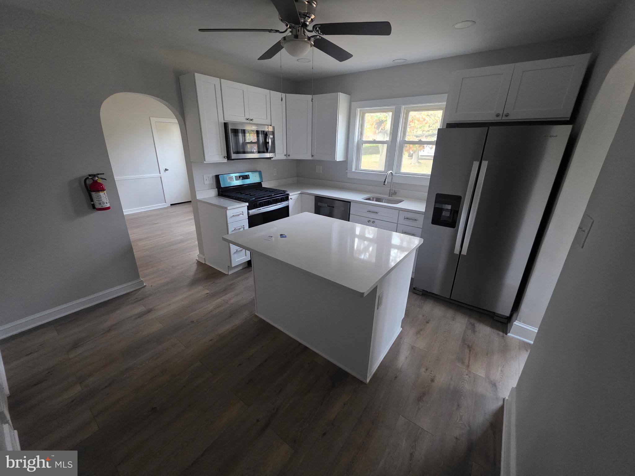 105 Mecray Lane Maple Shade, NJ 08052 - Photo 7 of 12 a large kitchen with a sink a refrigerator and a stove top oven