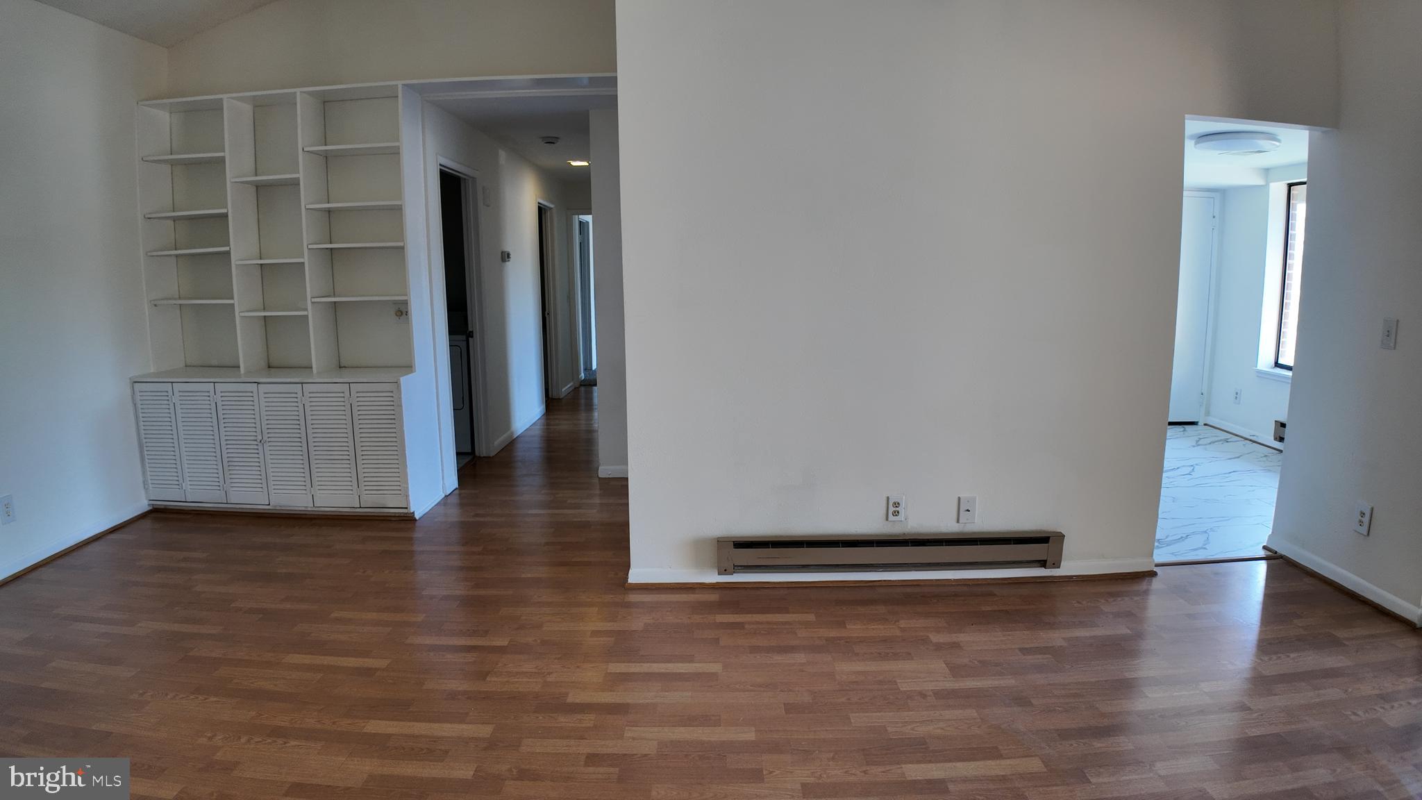 15311 Beaverbrook Court, Unit 903B Silver Spring, MD 20906 - Photo 11 of 36 an empty room with wooden floor and windows