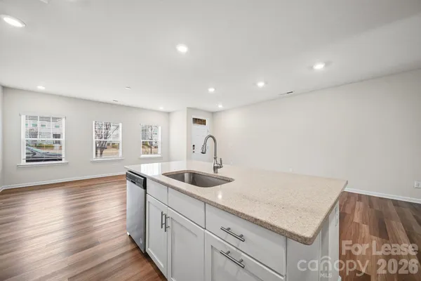 a kitchen with sink and cabinets