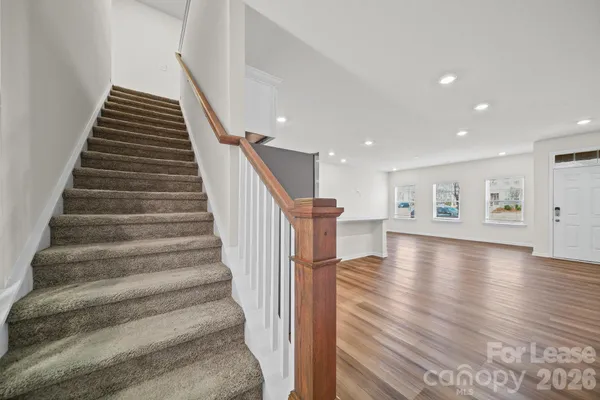 a view of entryway and hall with wooden floor