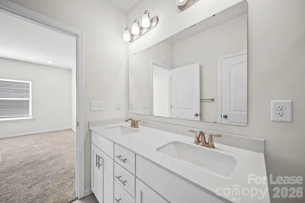 a bathroom with double sink and a mirror