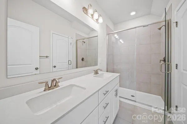a bathroom with a sink double vanity and shower